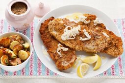 Wiener schnitzel (breaded veal escalope from Vienna) with horseradish and roast potatoes