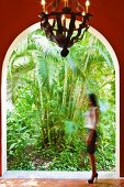 View of lush, exotic plants through rounded archway