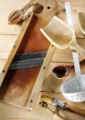 Kitchen utensils on a pale wooden surface