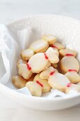 Sweetie-shaped biscuits in a white dish with a flower design