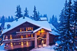 Alpine hotel in twilit winter landscape