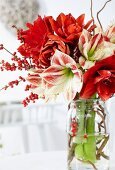 Winter bouquet with amaryllis and sprigs of winterberry