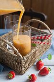 Fruit smoothie being poured into a glass