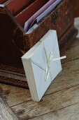 Envelopes bound with silk ribbon leaning on antique letter rack