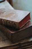 Antiquarian books with gilt embossing on worn leather bindings