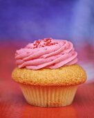A cupcake topped with raspberry cream
