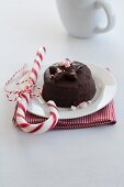A miniature chocolate torte with a candy cane at Christmas