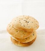 A stack of pita breads with sesame seeds