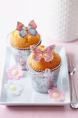 Muffins decorating with butterflies and flowers made from edible paper