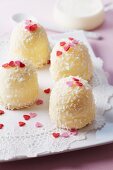 White marshmallow kisses with grated coconut and sugar hearts