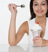Smiling woman with ice cream sundae
