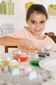 Girl coloring Easter eggs