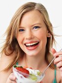 Woman eating fruit salad