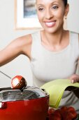 Woman dipping strawberries in chocolate mousse