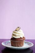 A chocolate cupcake topped with cream