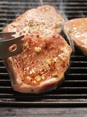 Spiced pork steaks on the barbecue