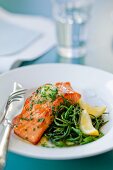 Salmon fillet with herb butter, glasswort and lemons