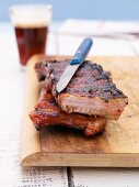 Marinated, BBQ spare ribs on a wooden board