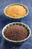 Black and white mustard seeds in small bowls