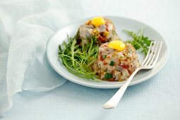 Herring tartar with dried tomatoes, pickled gherkins and quail's eggs