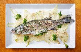 Baked bass with parsley and lemon on a bed of fennel