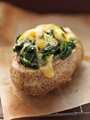 Twice-baked potato topped with cheese and spinach