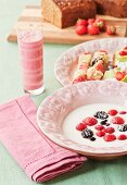 A Swedish breakfast of berries in sour milk, fruit and coconut skewers and raspberry and kiwi smoothies