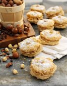 Coffee and hazelnut whoopie pies with icing sugar, nuts and coffee beans