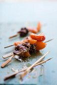 Apricot skewers with duck and sesame seeds