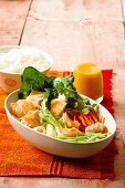 A salad of rice noodles with salmon and sweet and sour sauce