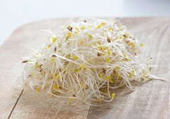 Alfalfa sprouts on a wooden board