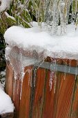 Snowy and icy wooden tub