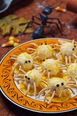 Halloween spiders made of cream cheese and savoury snacks