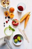 A still life of cereals, fruits, a glass of milk and fruit juice