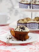 Caffe latte cupcakes, one on a plate and more on a cake stand