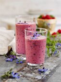 A berry and banana shake with apples and borage flowers