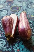 Striped aubergines, whole and halved
