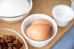 Eggs, sugar, raisins and salt as ingredients for batter