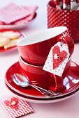 Two stacked teacups and tag with heart for romantic message