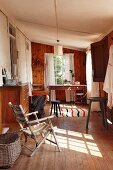 Assorted vintage furniture in a narrow room with wood paneling, white, profiled sheet metal and wood flooring