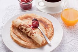 Pancakes with jam, coffee and orange juice