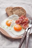 Fried eggs with bacon and bread