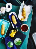 Corn dogs (sausages wrapped in polenta) on sticks