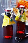 Drink bottles decorated with napkins and clothes pegs