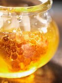 Honey with honeycomb in a jar (close-up)