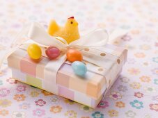 An Easter parcel with a fondant chick and sugar eggs