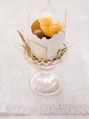 An Easter nest in an eggcup with sweets