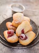 Madeleines with raspberries and icing sugar