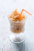 Melon granita in a glass with a drinking straw