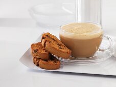 A cup of caffe latte with biscotti